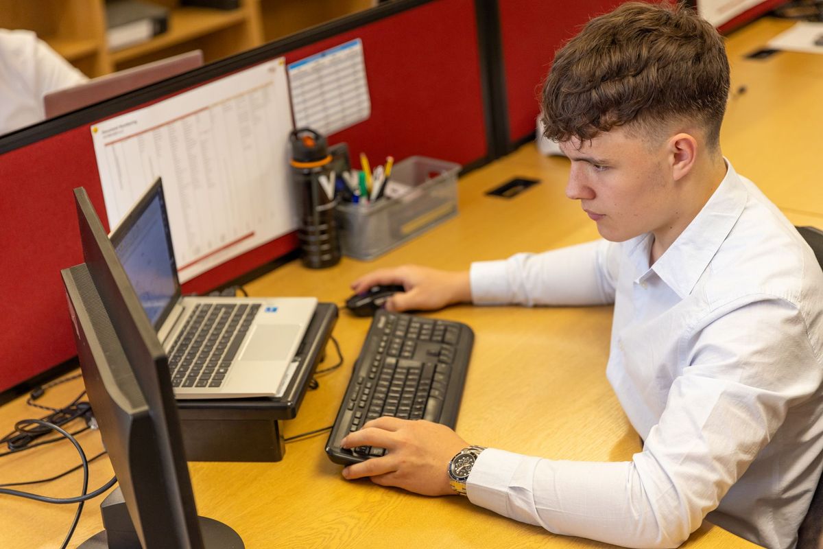 Computer technician installing an upgraded component inside a desktop PC