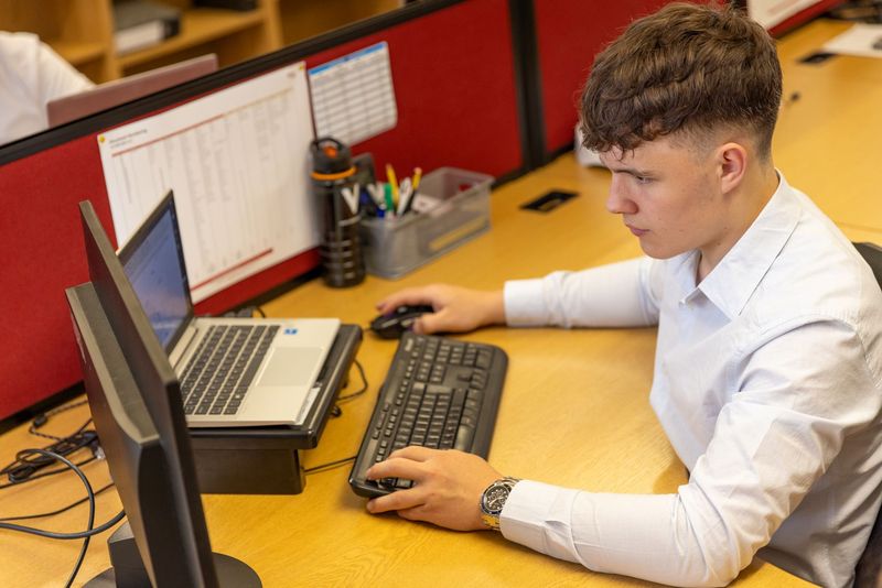 Technician setting up a secure data backup workflow on a laptop