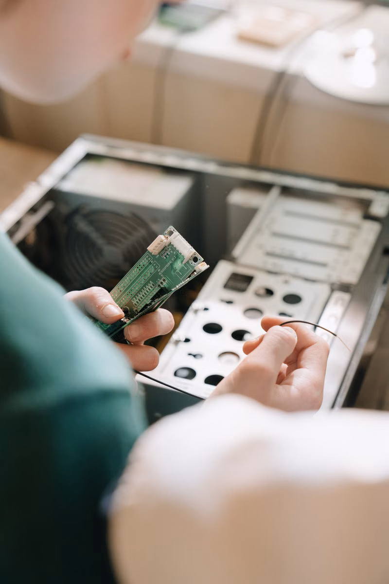 Technician installing memory into a desktop computer