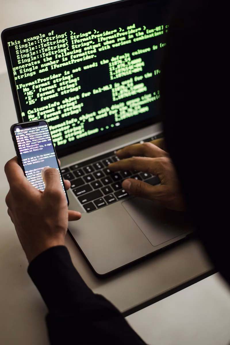 Laptop and password security notes on a service desk