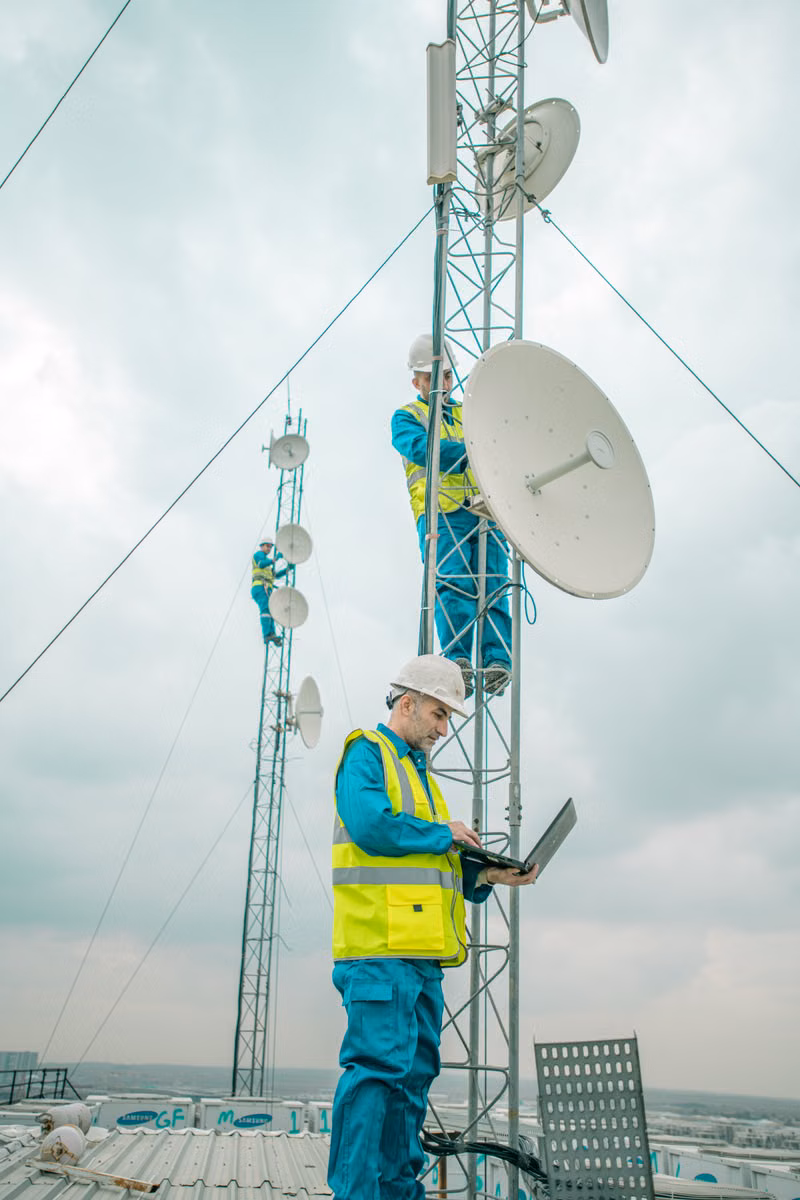 Technician using a laptop to test wireless network performance